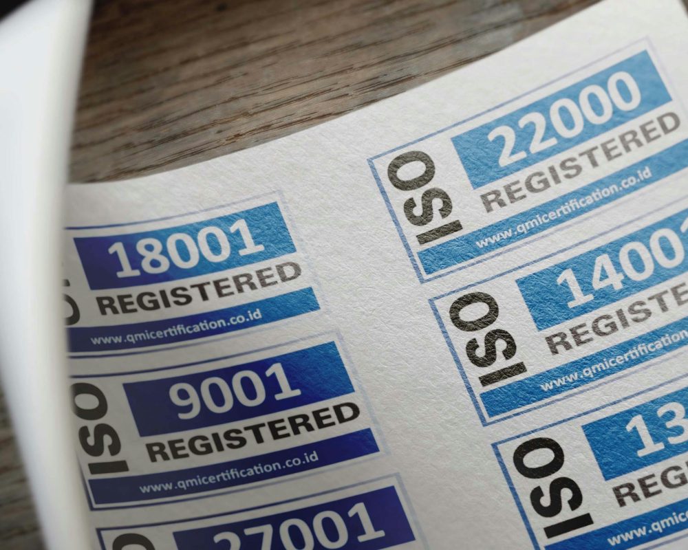 ISO certification stickers with registration numbers on paper.